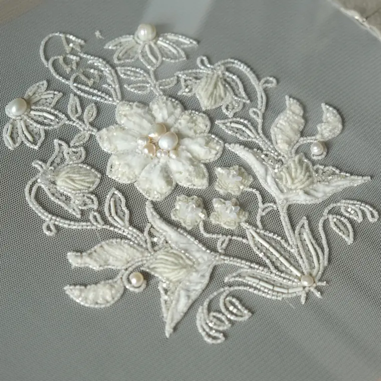 Textured monochrome embroidery appliqué for a sweater, bonus course project