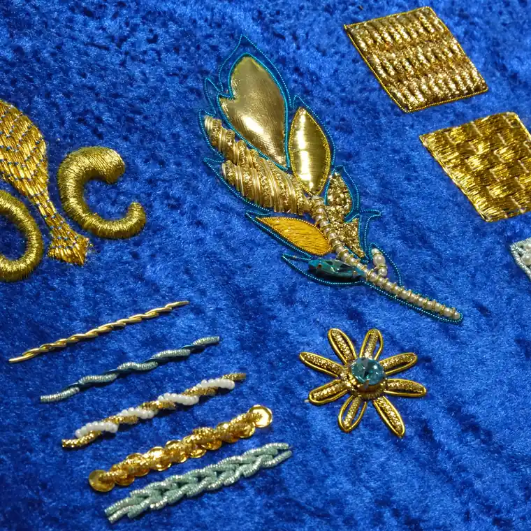 Goldwork technique samples, fleur de lis, feather and purl work on blue velvet