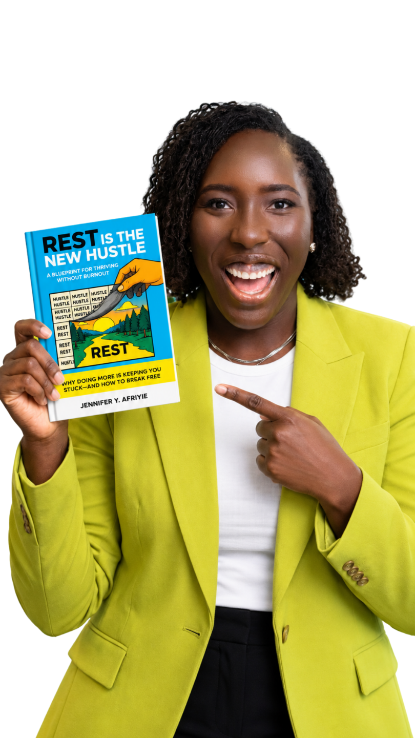 Jennifer Y. Afriyie holding her book, Rest Is the New Hustle