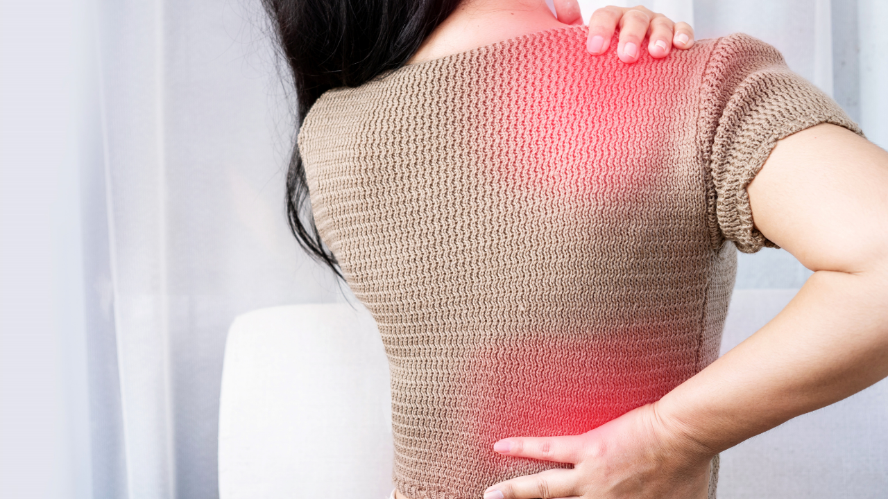Person experiencing back pain with highlighted inflammation areas illustrating chronic inflammation and pain