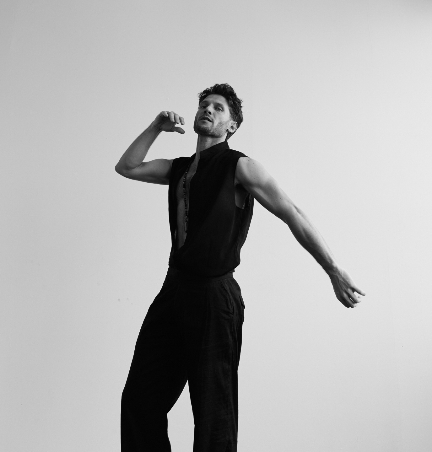 Alessandro dancing, one arm raised