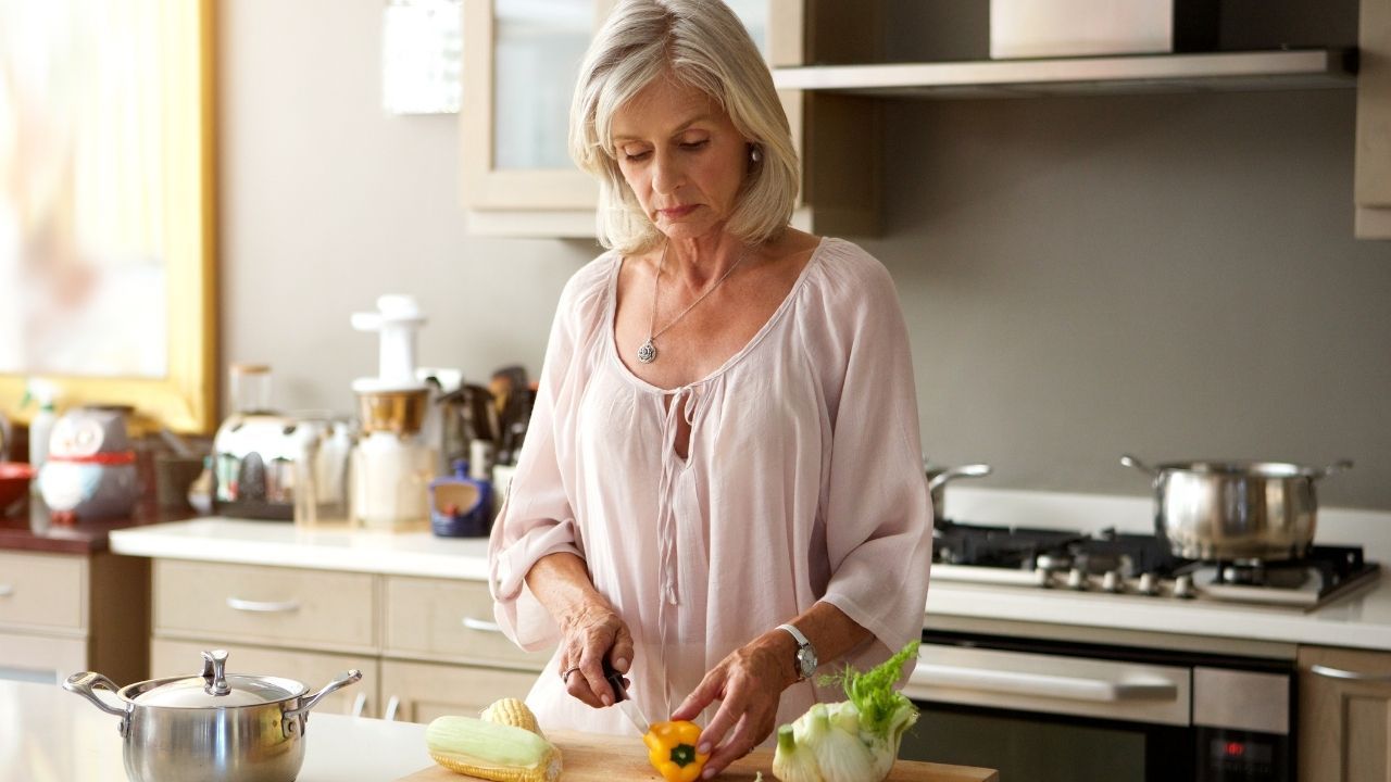 Woman preparing a balanced meal to support hormone health in midlife