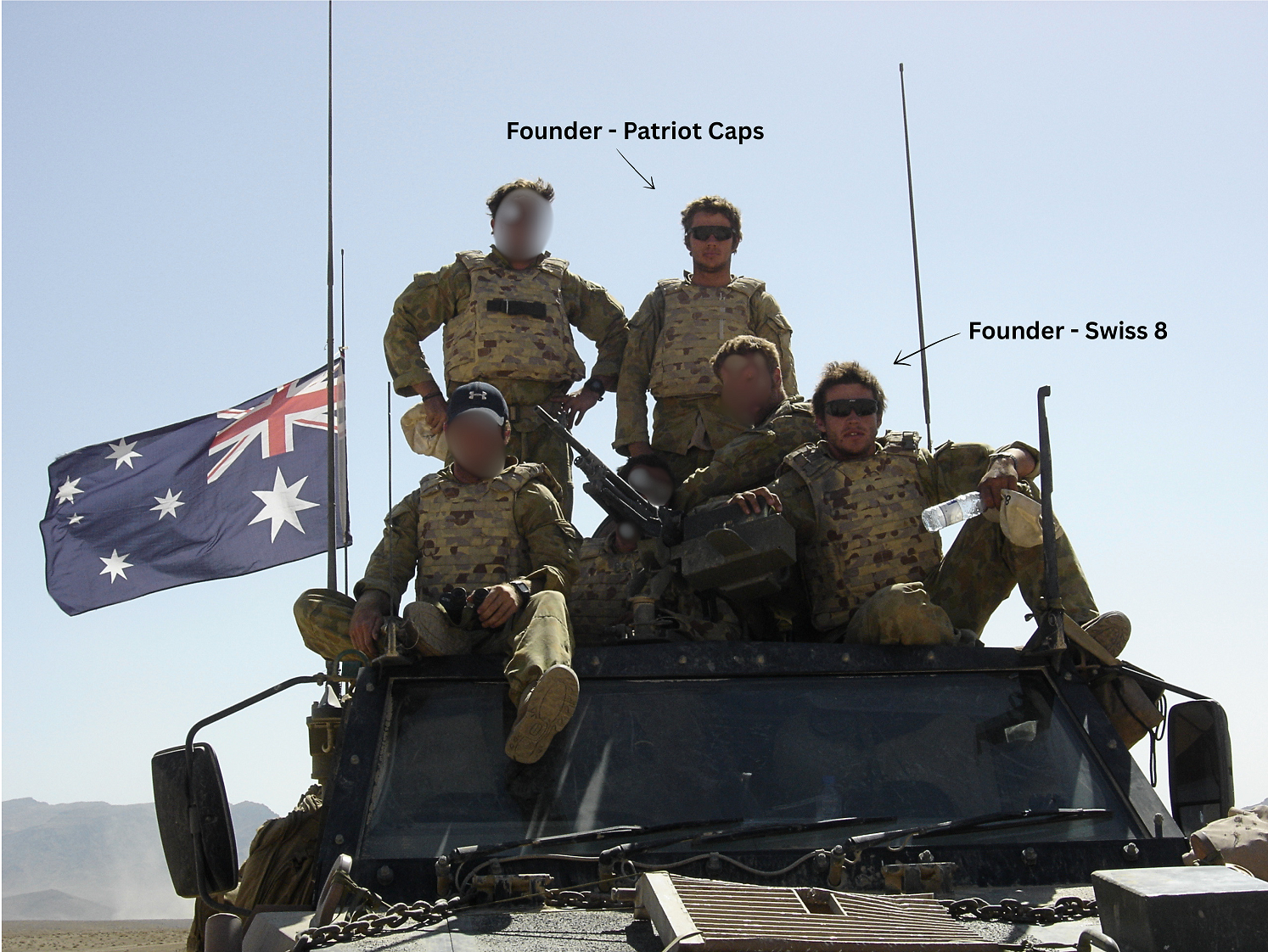 Australian soldiers with a flag on an armoured vehicle in Afghanistan, with the Founder of Patriot Caps and the Founder of Swiss 8 labelled