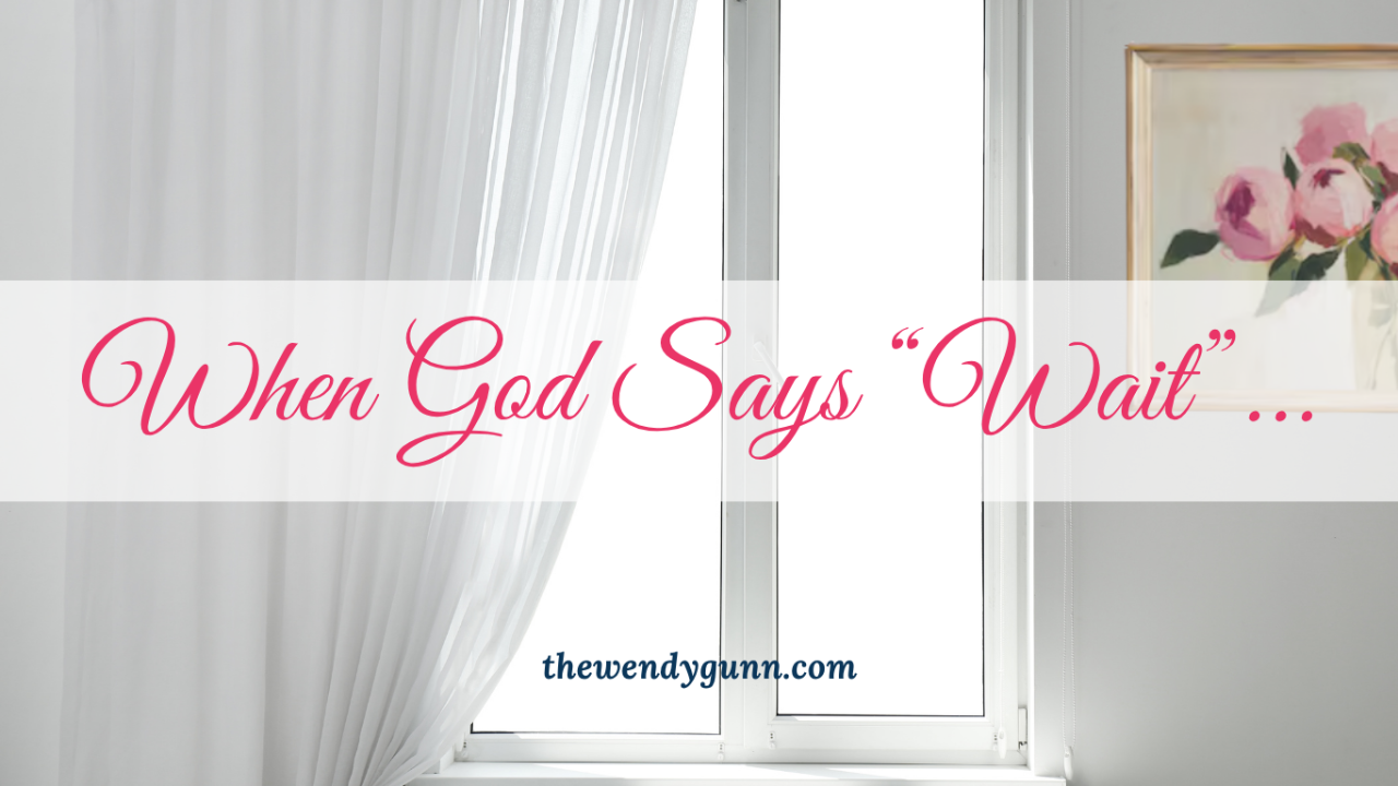 Inspirational graphic featuring a bright window with white curtains and the text: "When God Says 'Wait'..."