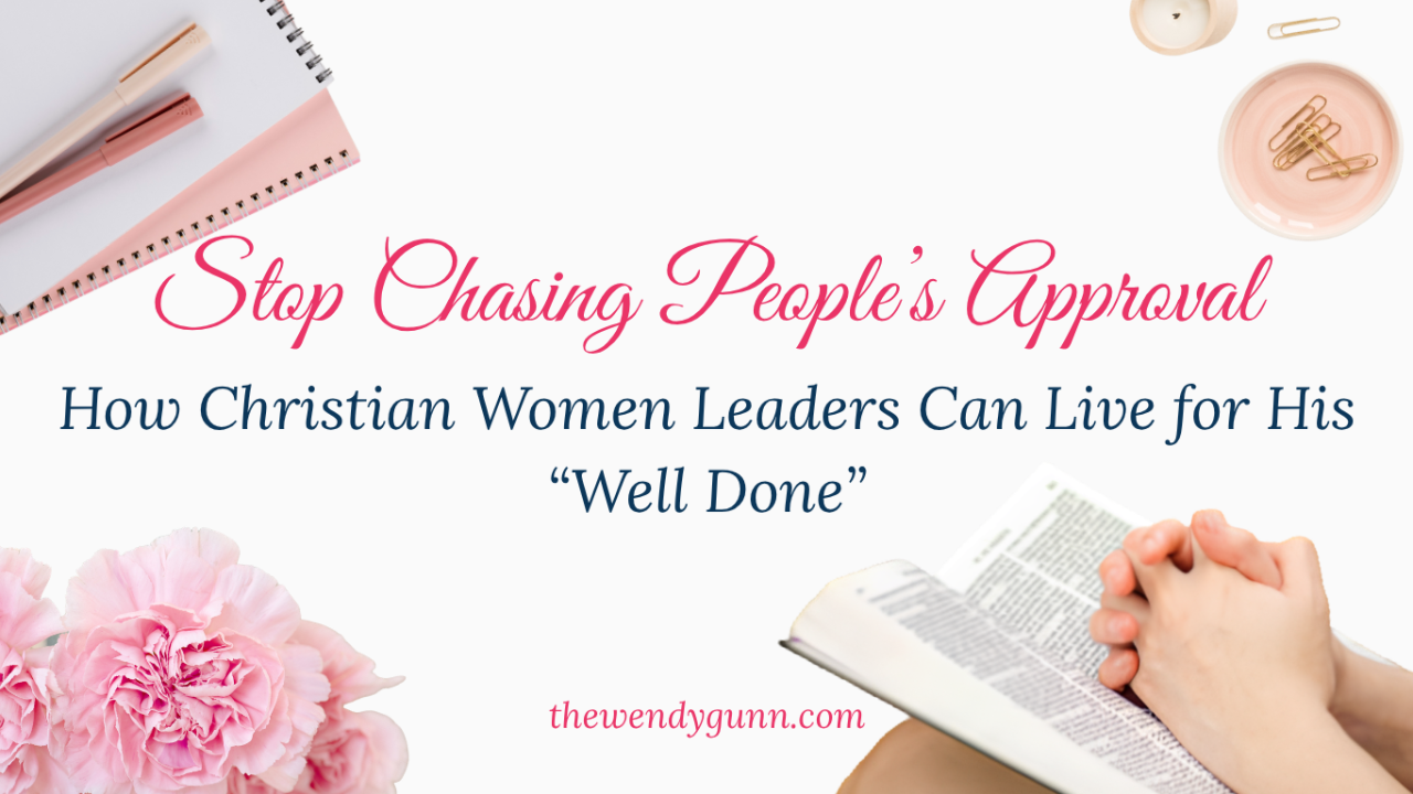 Hands clasped in prayer over an open Bible with soft pink flowers and stationery, featuring text about Christian women leaders living for God’s ‘well done’ instead of people’s approval.