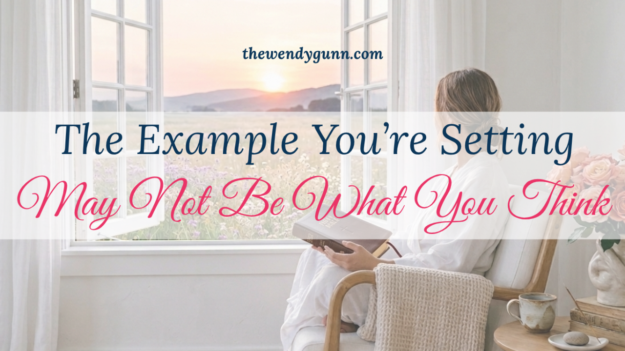 The Example You’re Setting May Not Be What You Think featured image showing a woman sitting by an open window reading a Bible at sunrise, with flowers outside and a peaceful home setting.