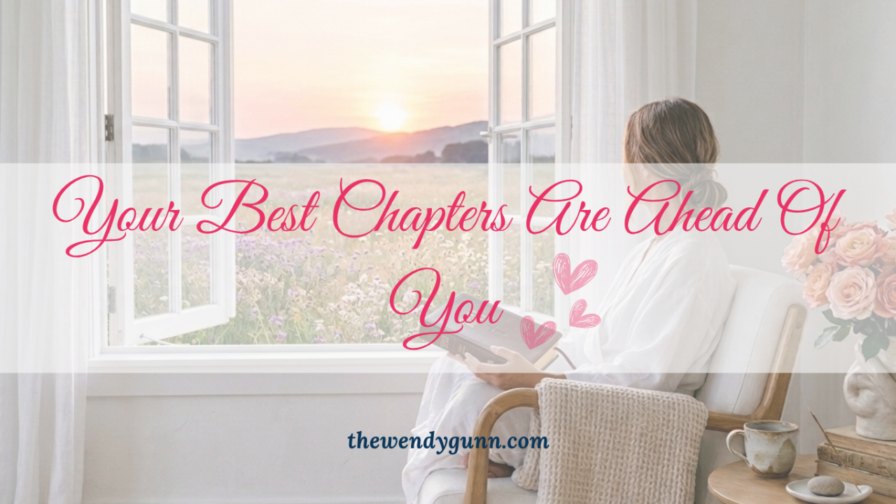 Inspirational graphic of a woman sitting by an open window overlooking a sunrise, with the text: "Your Best Chapters Are Ahead Of You."