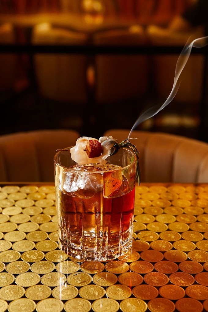 Rare Old Fashioned Specialty Cocktail with Smoking Rosemary Garnish