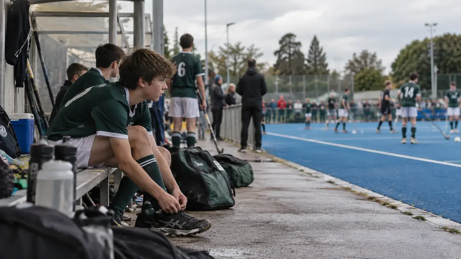 Young field hockey players waiting before a match