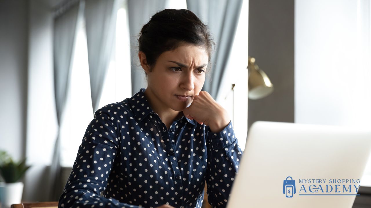 woman looking at laptop concerned about mystery shopping scams