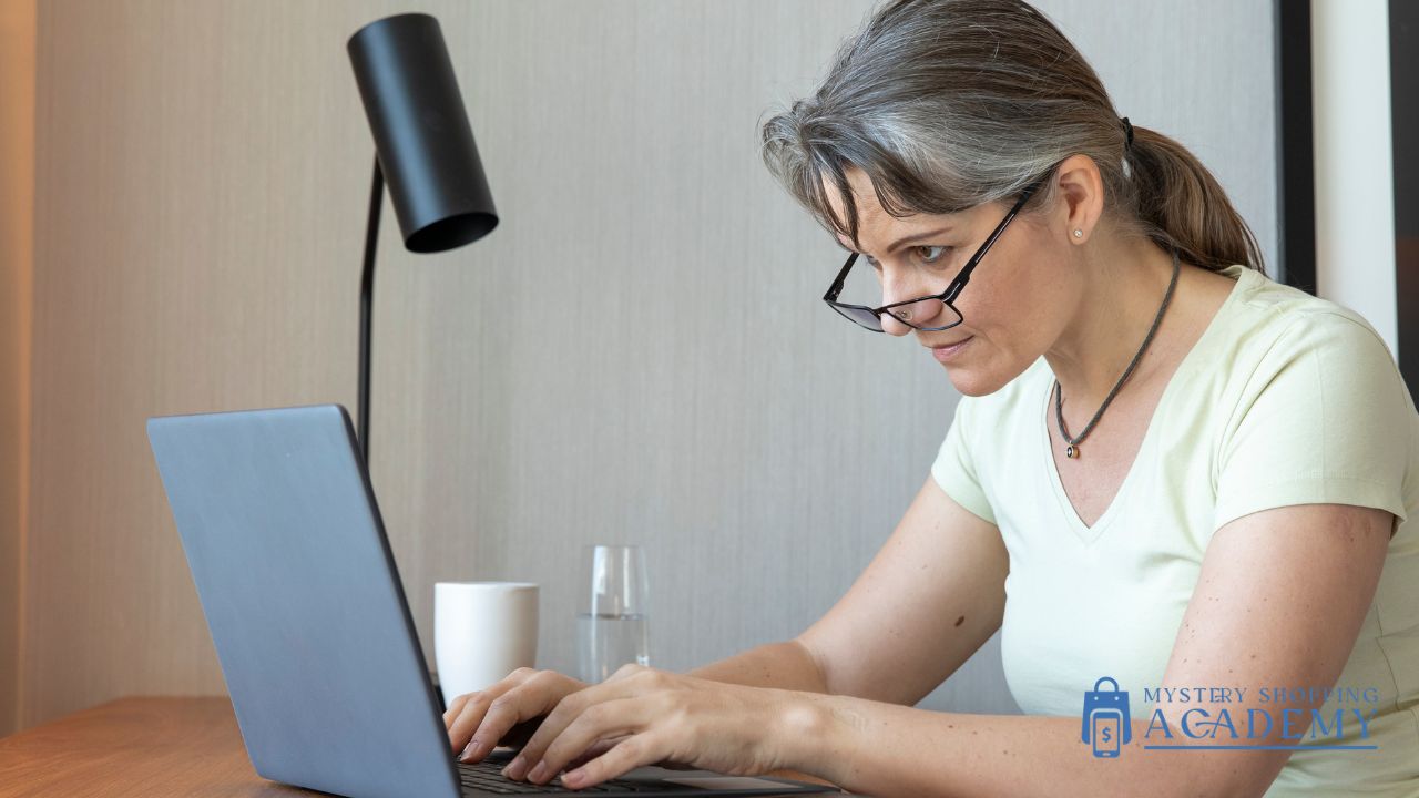 woman checking mystery shopping company lists on a laptop