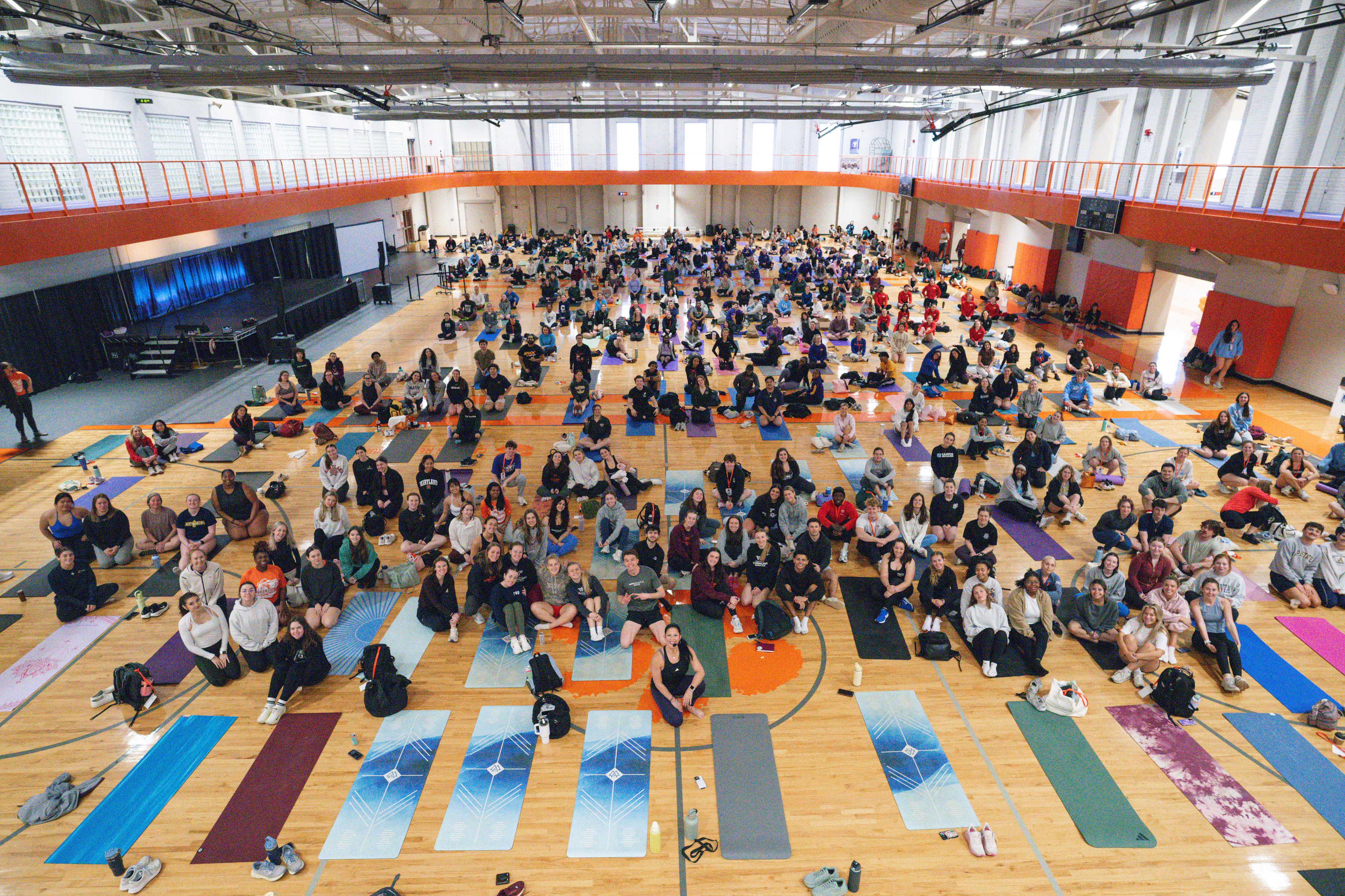 Hundreds of attendees in a mass group fitness class at FitExpo