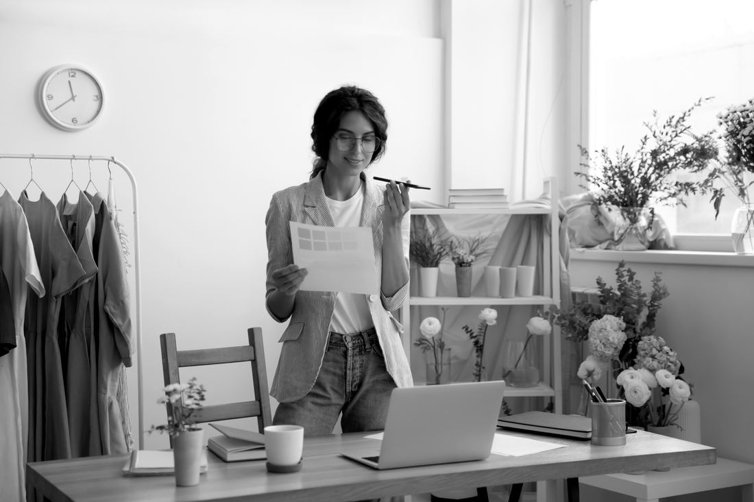 An assistant reviewing a color palette at a studio desk
