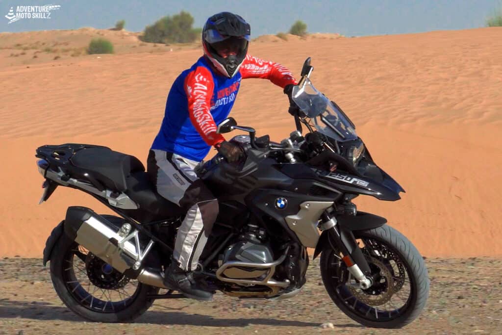 Adventure motorcycle rider off-road in a seated riding position
