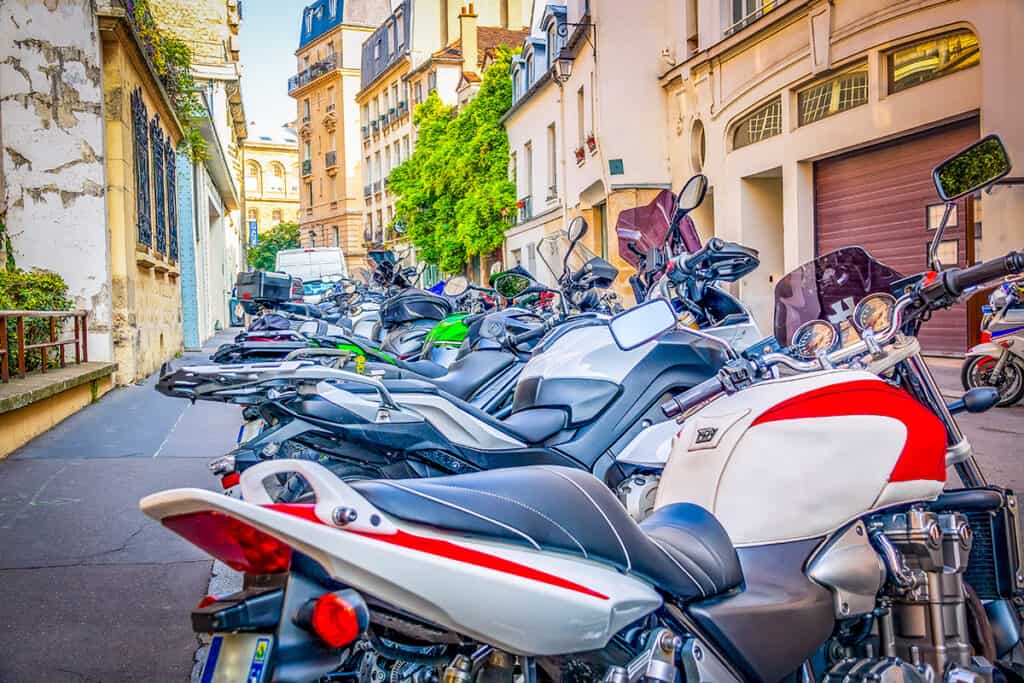 Multiple motorcycles parked on a city street