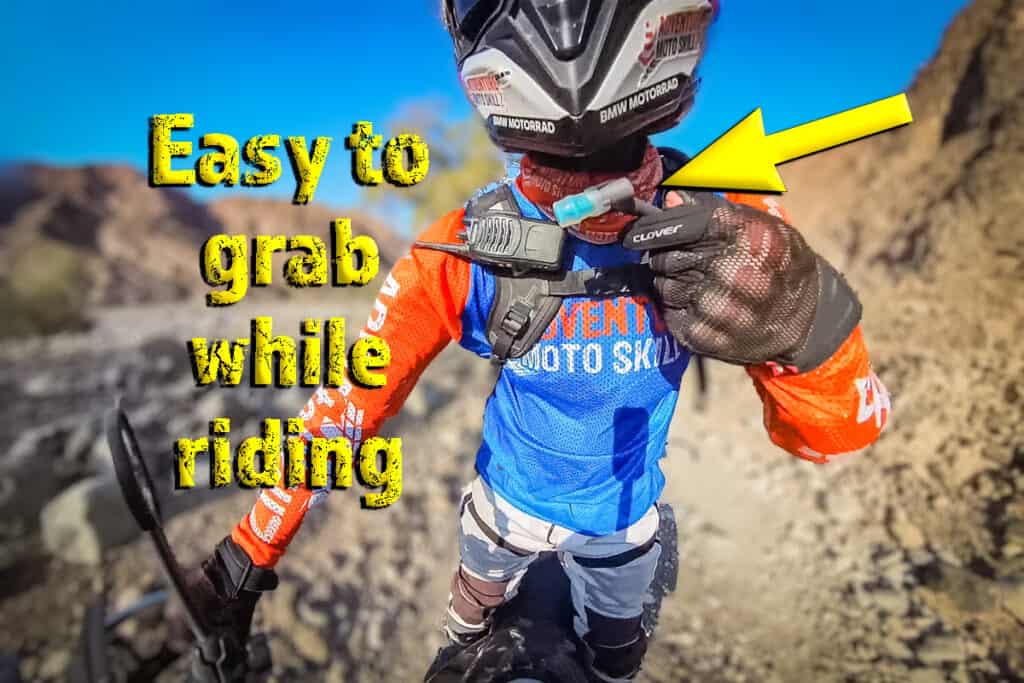 Motorcycle rider sipping from a hydration backpack while riding