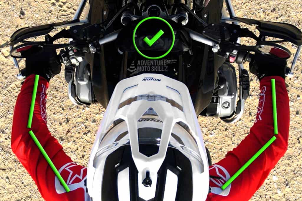 Overhead view of a rider keeping a slight bend in the elbows on an off-road motorcycle