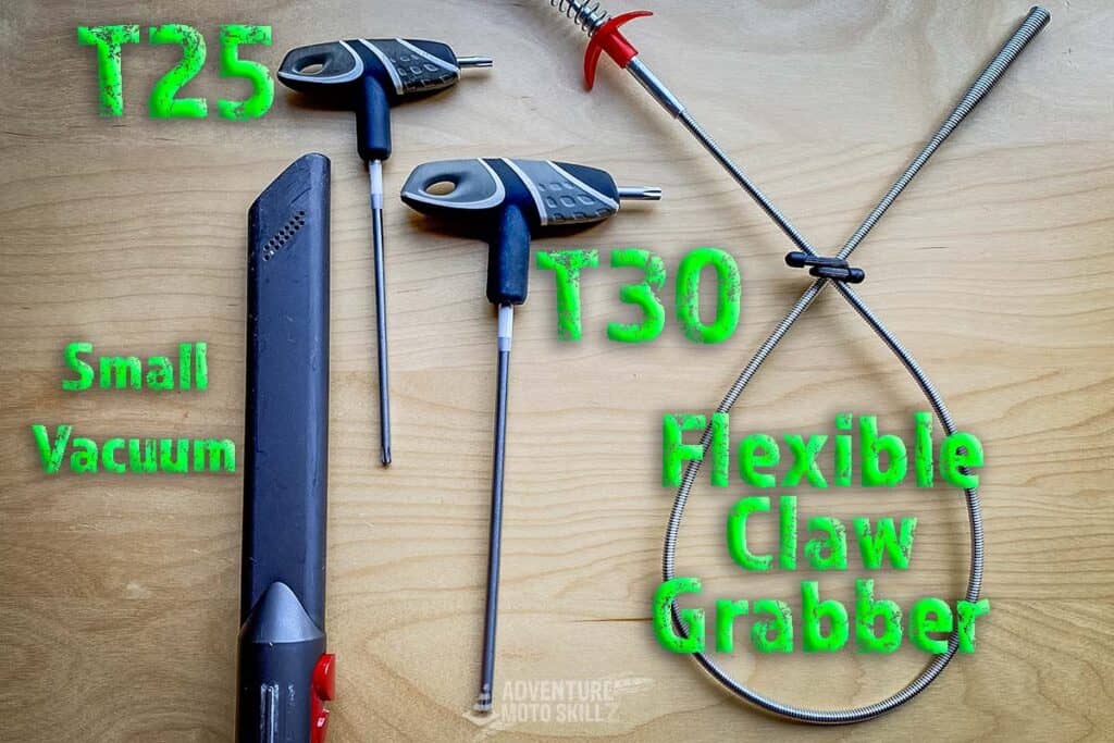 Tools for air filter cleaning: Torx T25 and T30 screwdrivers, handheld vacuum and flexible claw grabber