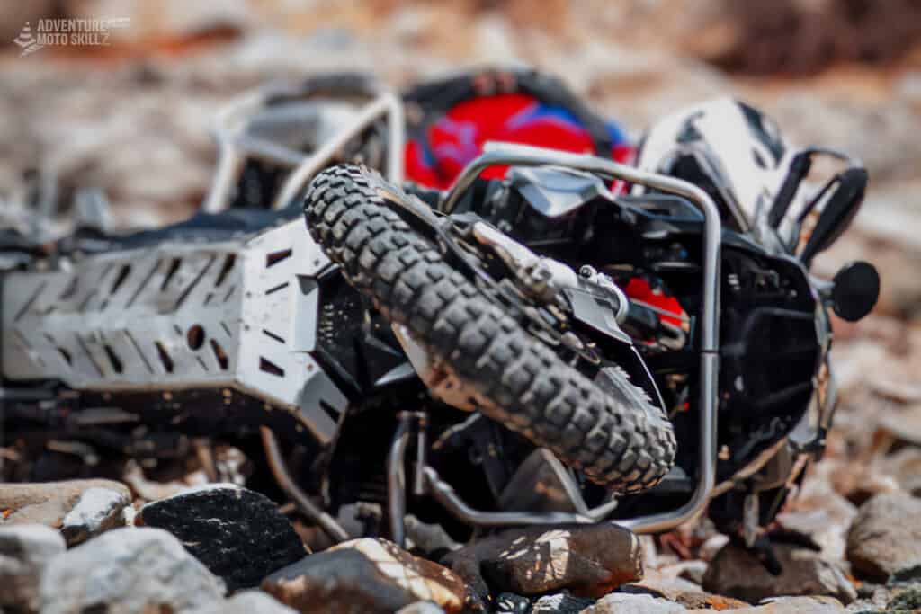 A fallen BMW R1200GS on rocky terrain
