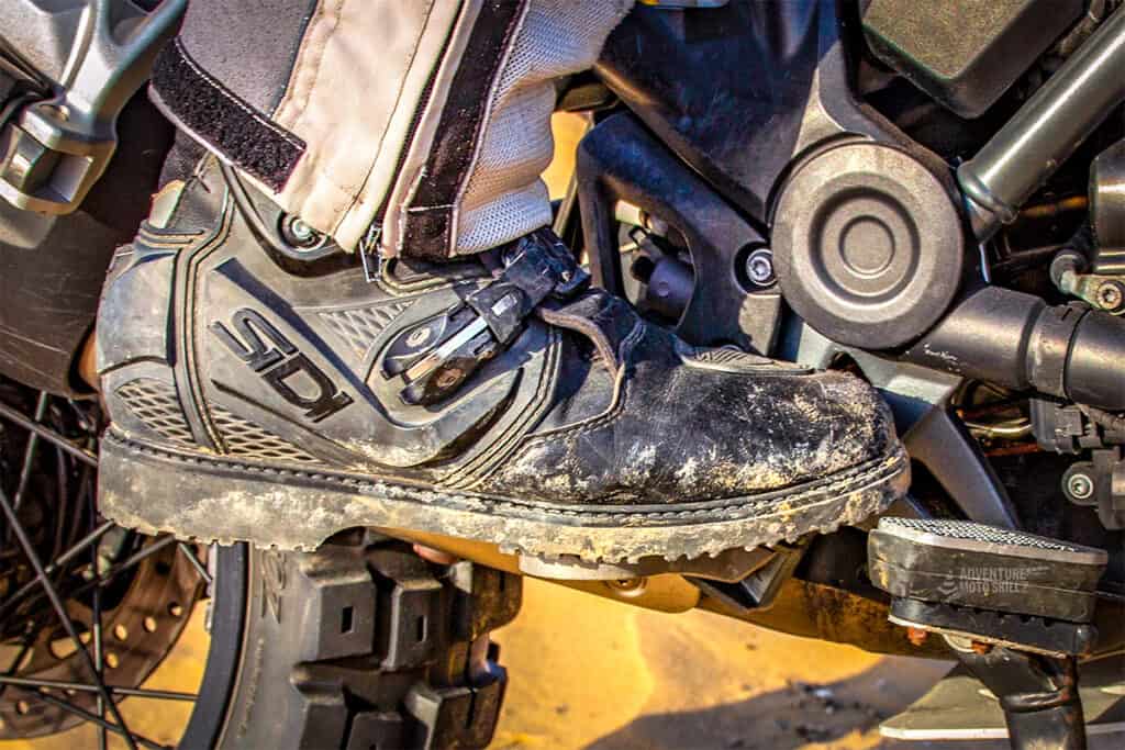 Close-up of an adventure motorcycle boot on the foot peg