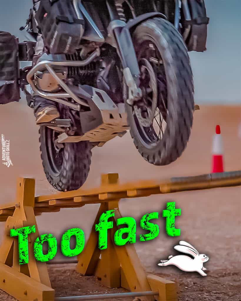 Rider on an ADV motorcycle riding up a teeter-totter plank