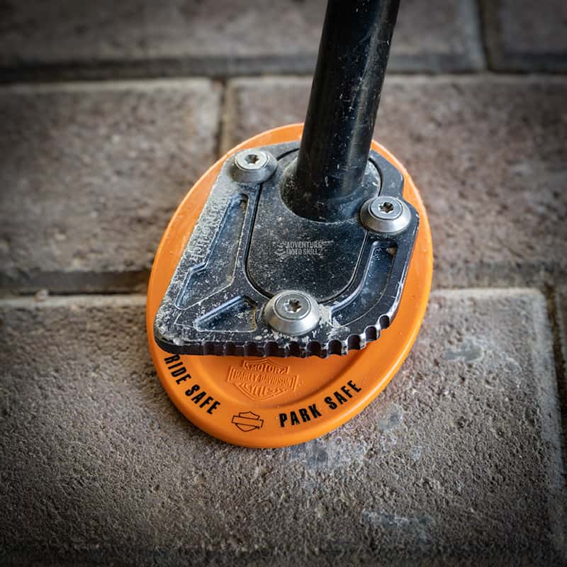 Kickstand coaster pad for parking a motorcycle