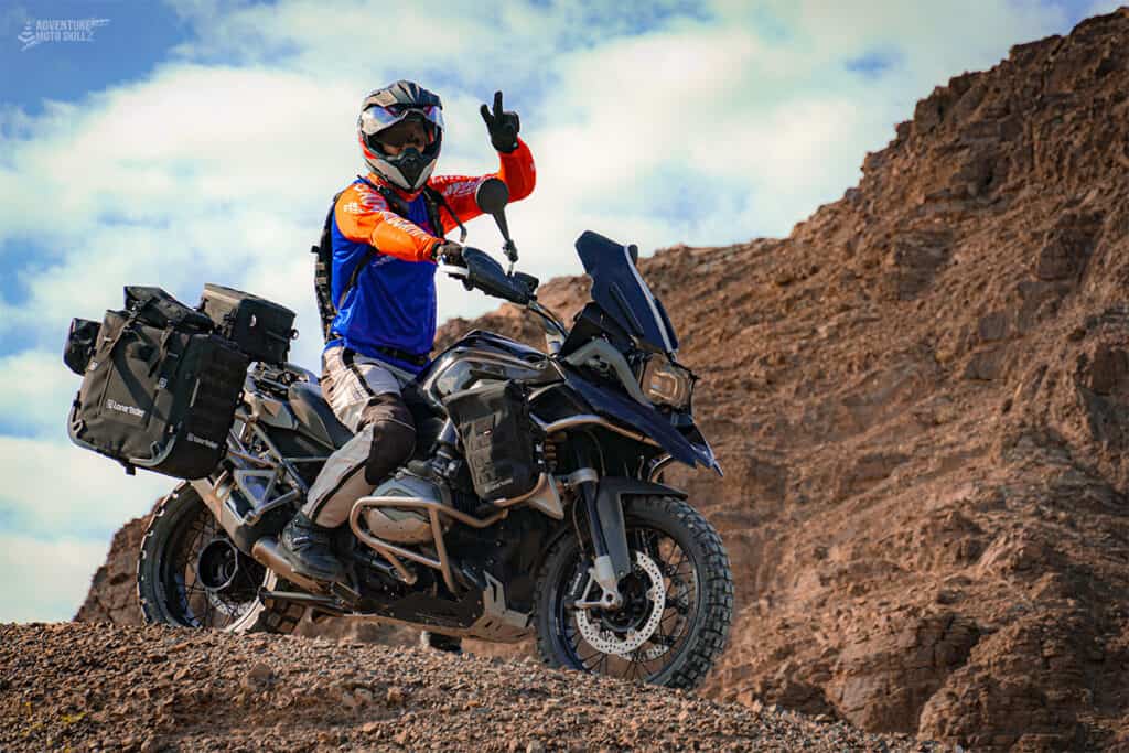 Motorcycle rider sitting on a BMW R1200GS in the mountains