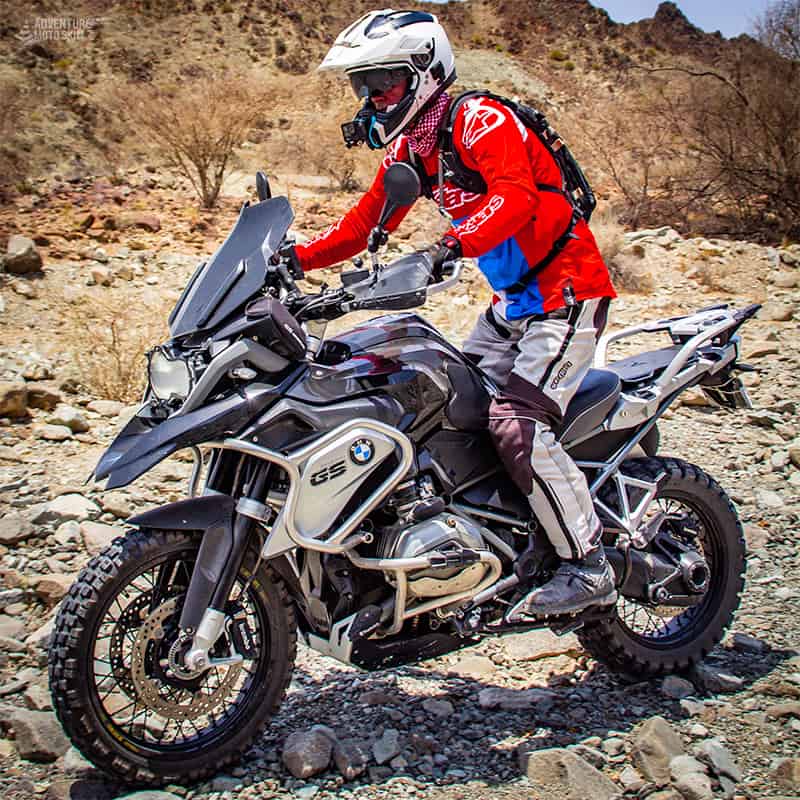 BMW R1200GS motorcycle riding over rocky off-road terrain