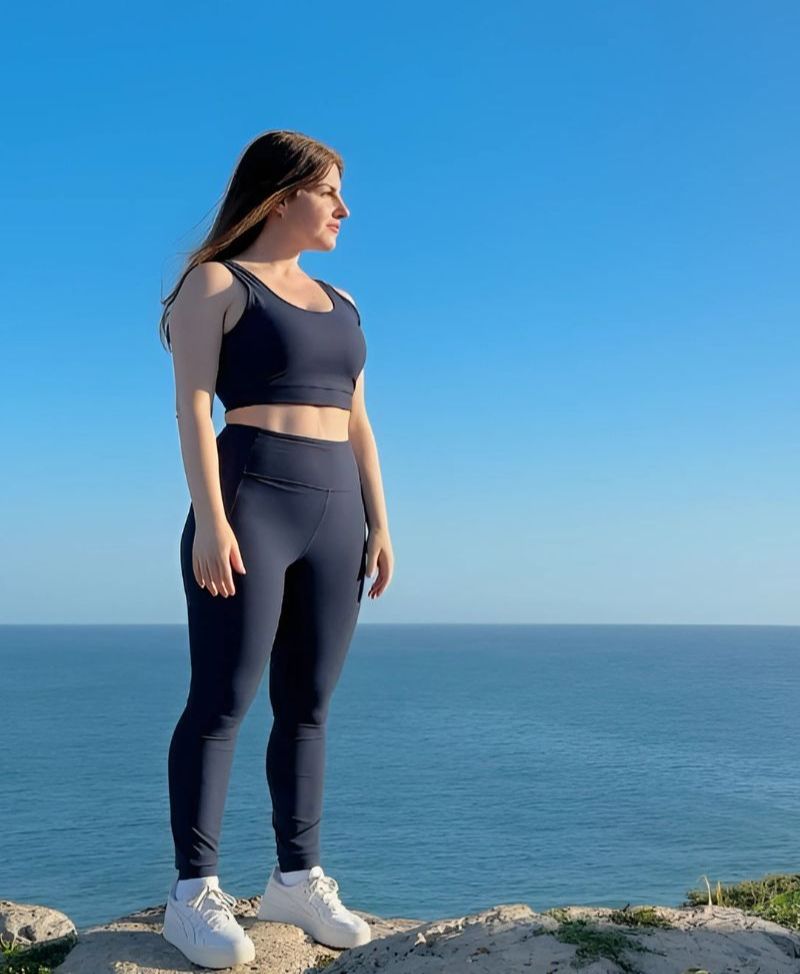 NARA standing by the ocean, representing the calm, strength, and energy of The RESET Program.
