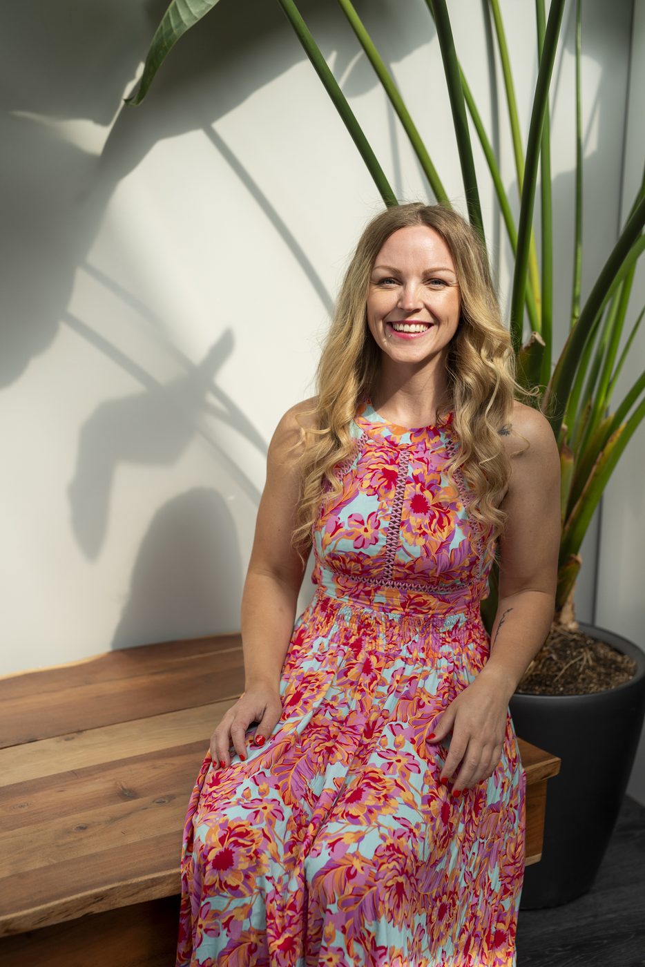 Cass Henry seated, smiling at the camera
