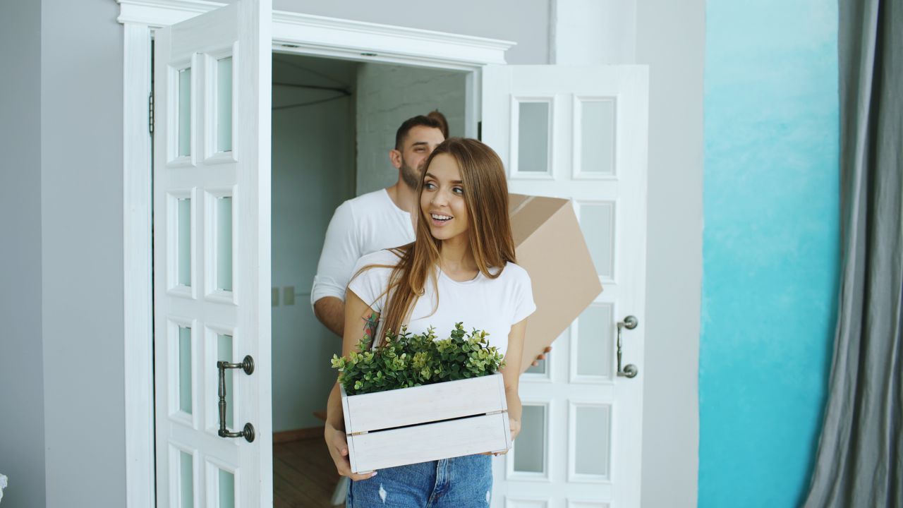 a young woman moving into her new home