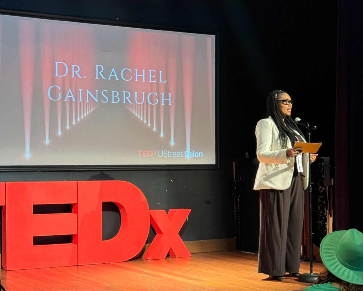 Dr. Rachel Gainsbrugh speaking on the TEDx U Street Salon stage