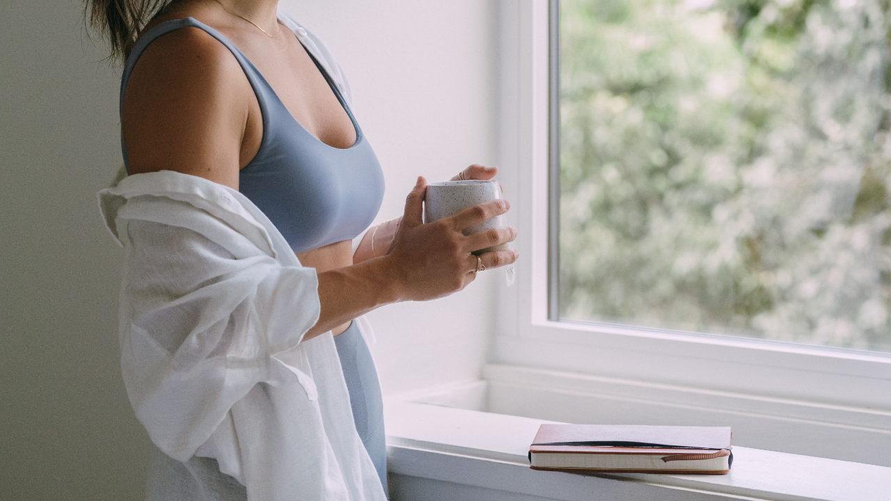 Highly sensitive woman sitting quietly in the morning feeling mentally overwhelmed and emotionally exhausted before starting the day
