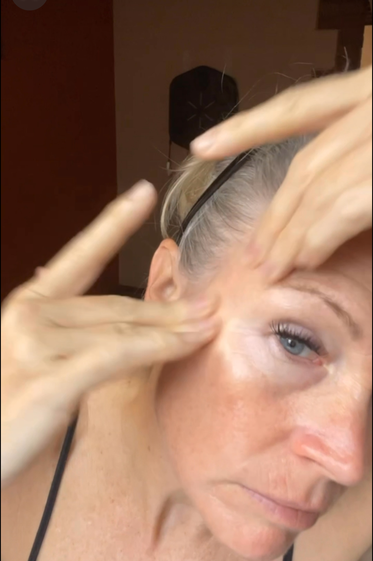 Liz doing a face yoga exercise