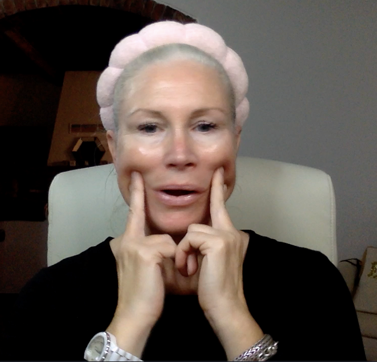 Liz doing a face yoga exercise