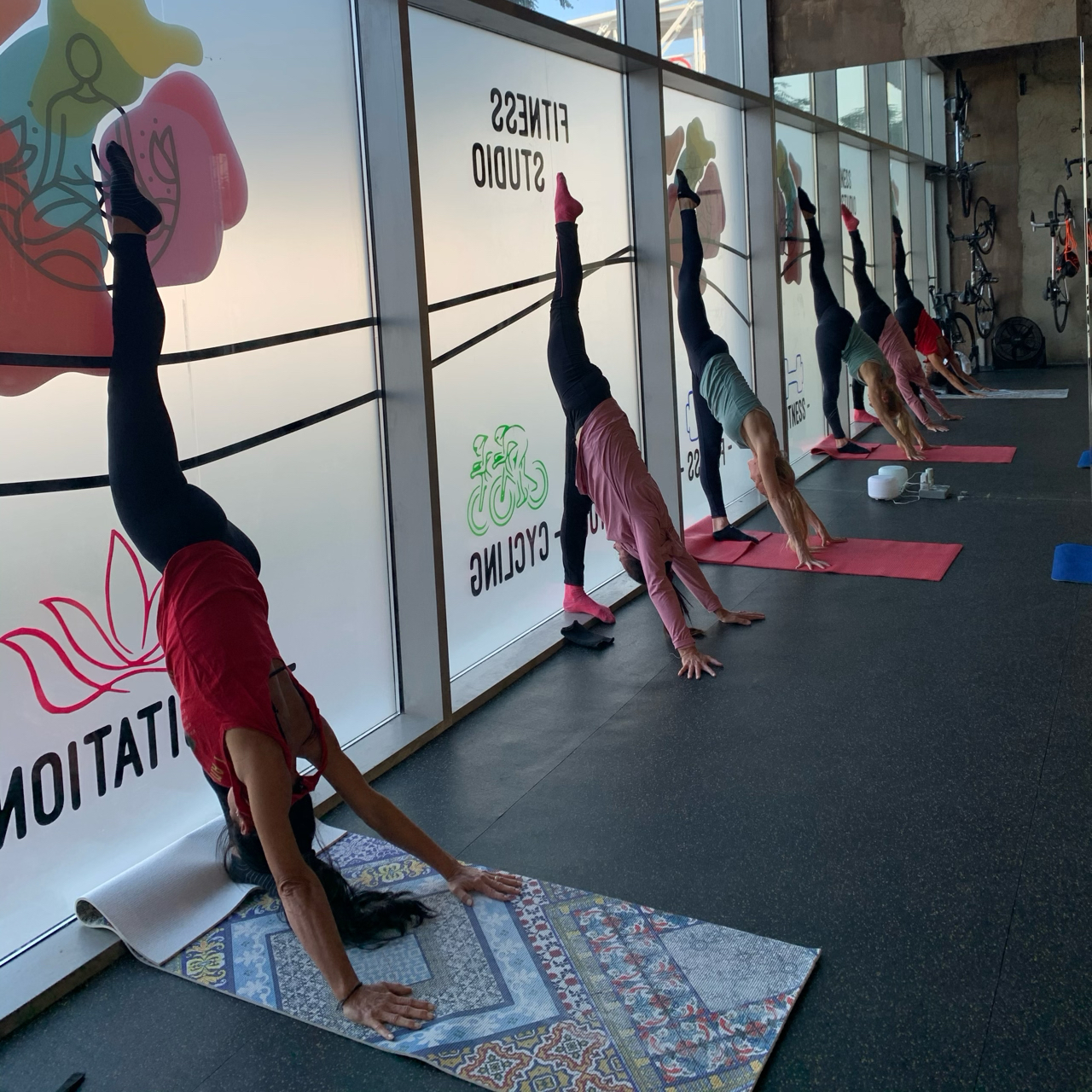 Regina H. in an inverted split pose