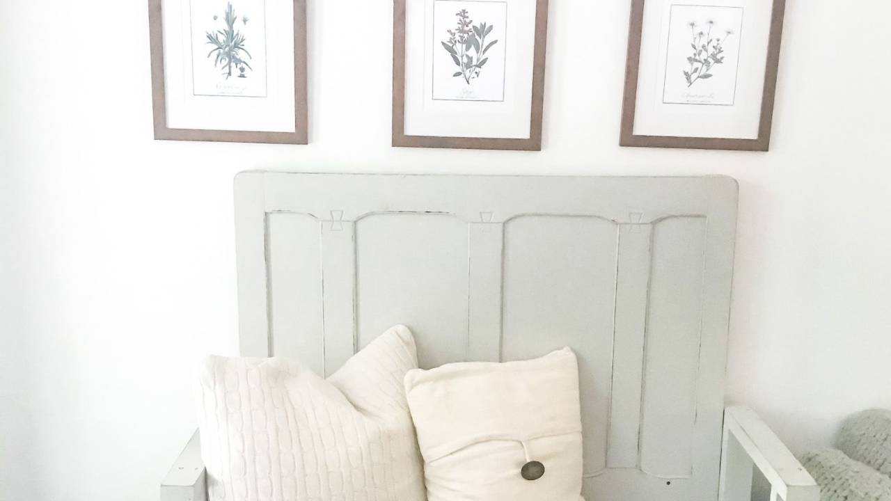 Cozy bedroom corner with framed botanical prints