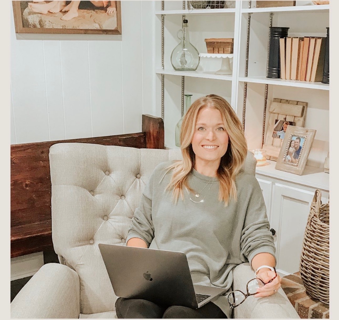 Jess smiling in her office with her laptop