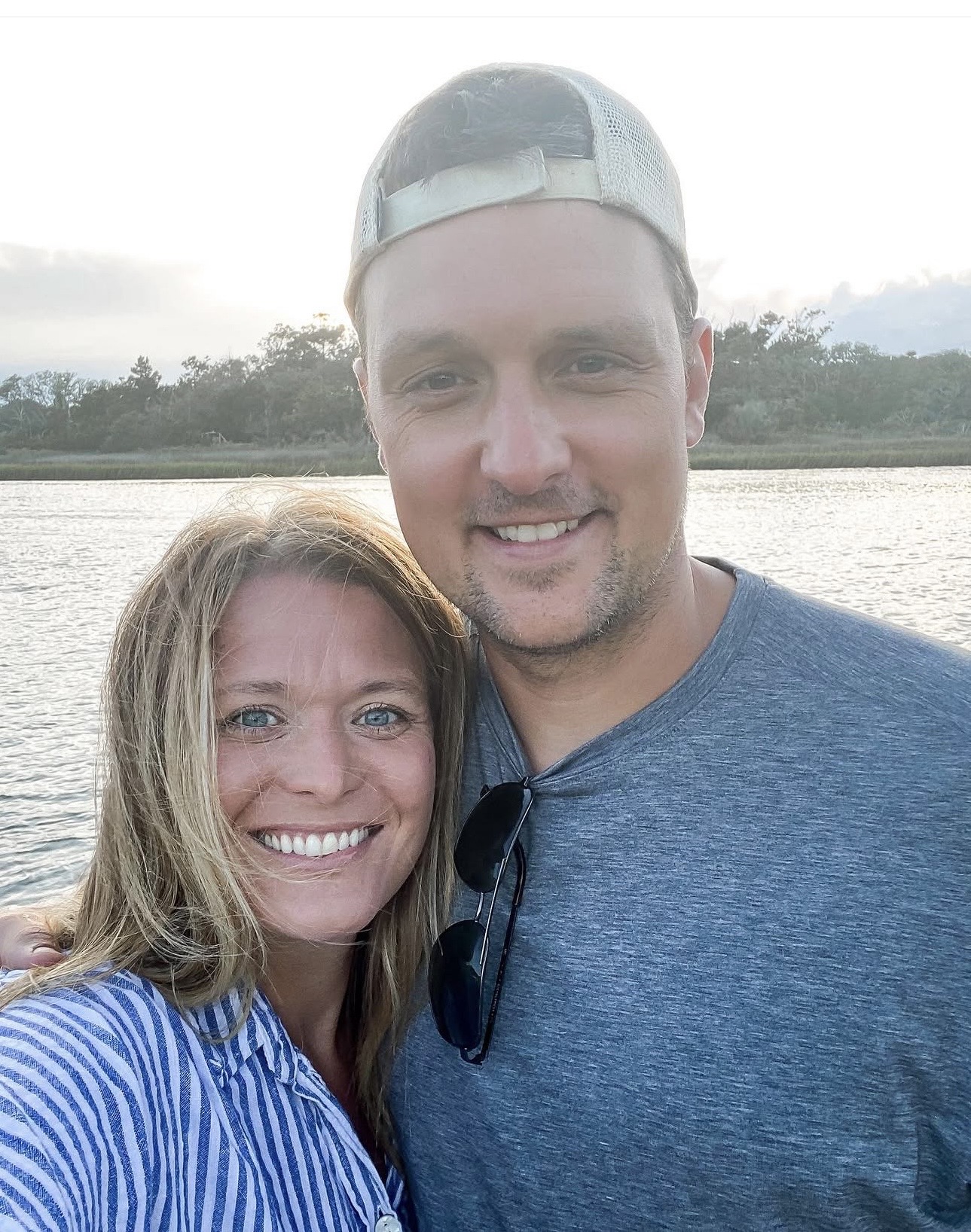 Jess and her husband, Trae, smiling together by the water