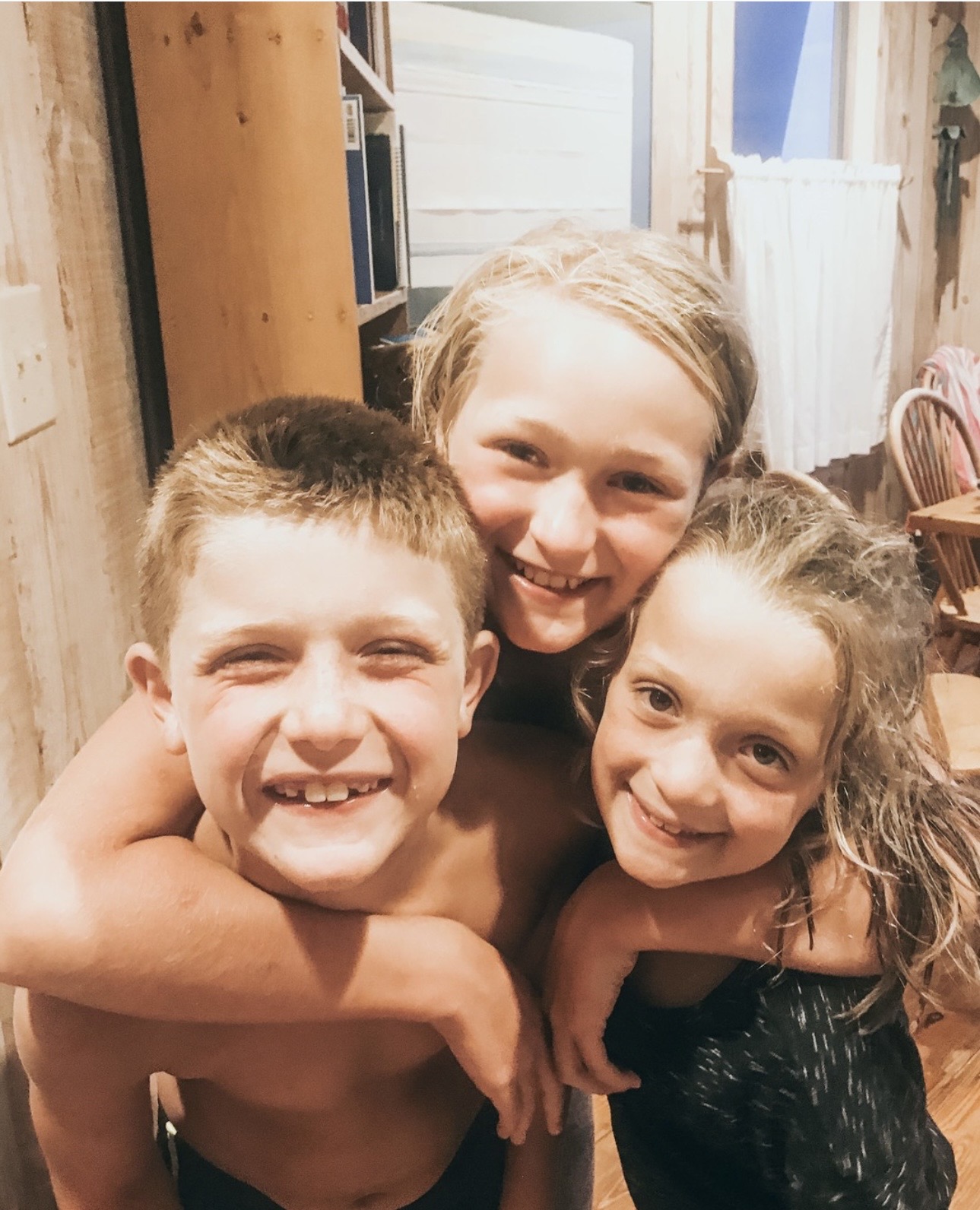 Jess’s three kids hugging each other