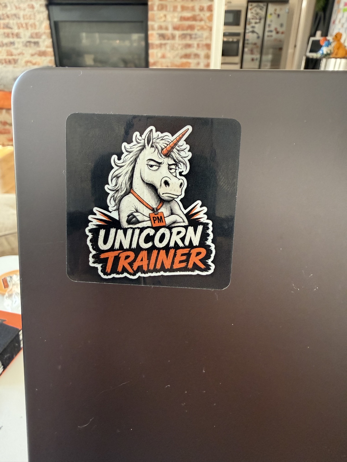 Unicorn Trainer sticker on the lid of a laptop