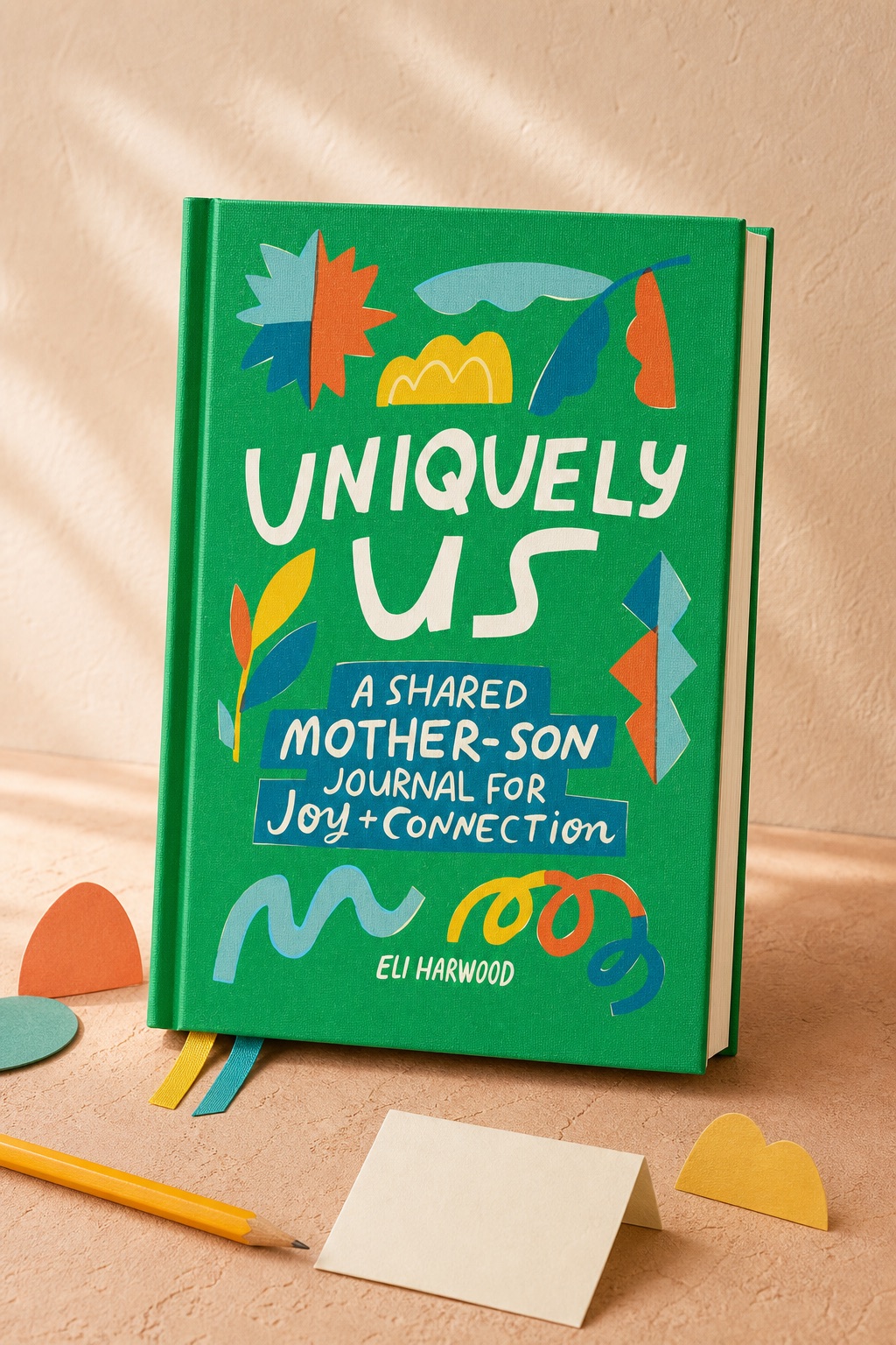 Uniquely Us Mother & Son journal displayed with a pencil and colorful paper shapes