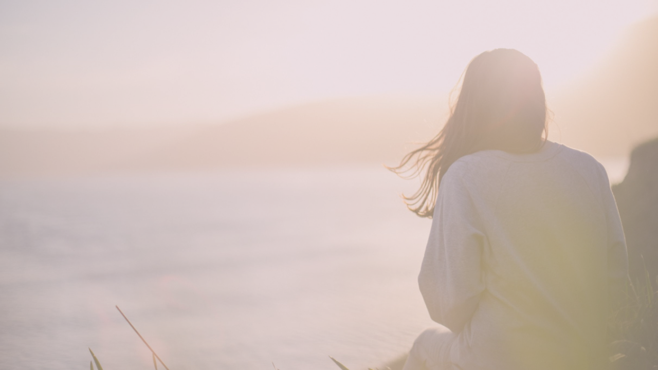 woman in perimenopause looking out over the clouds