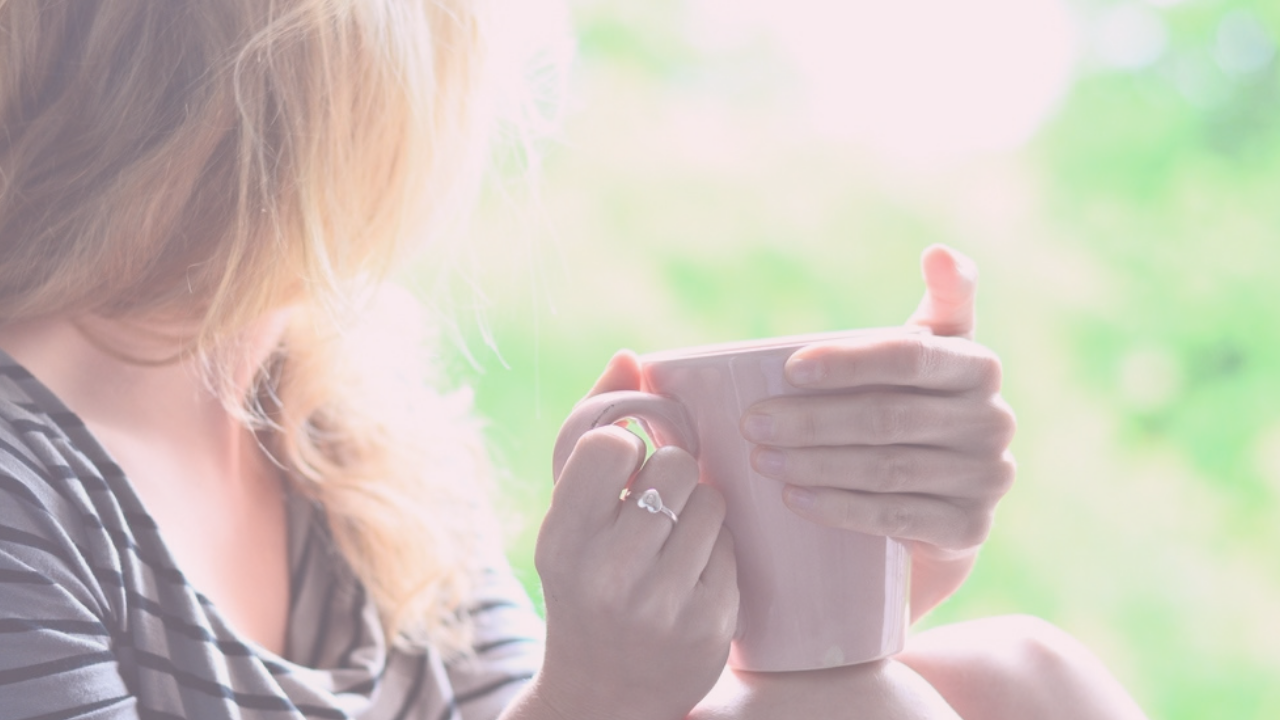 woman in perimenopause looking out of the window to relieve stress