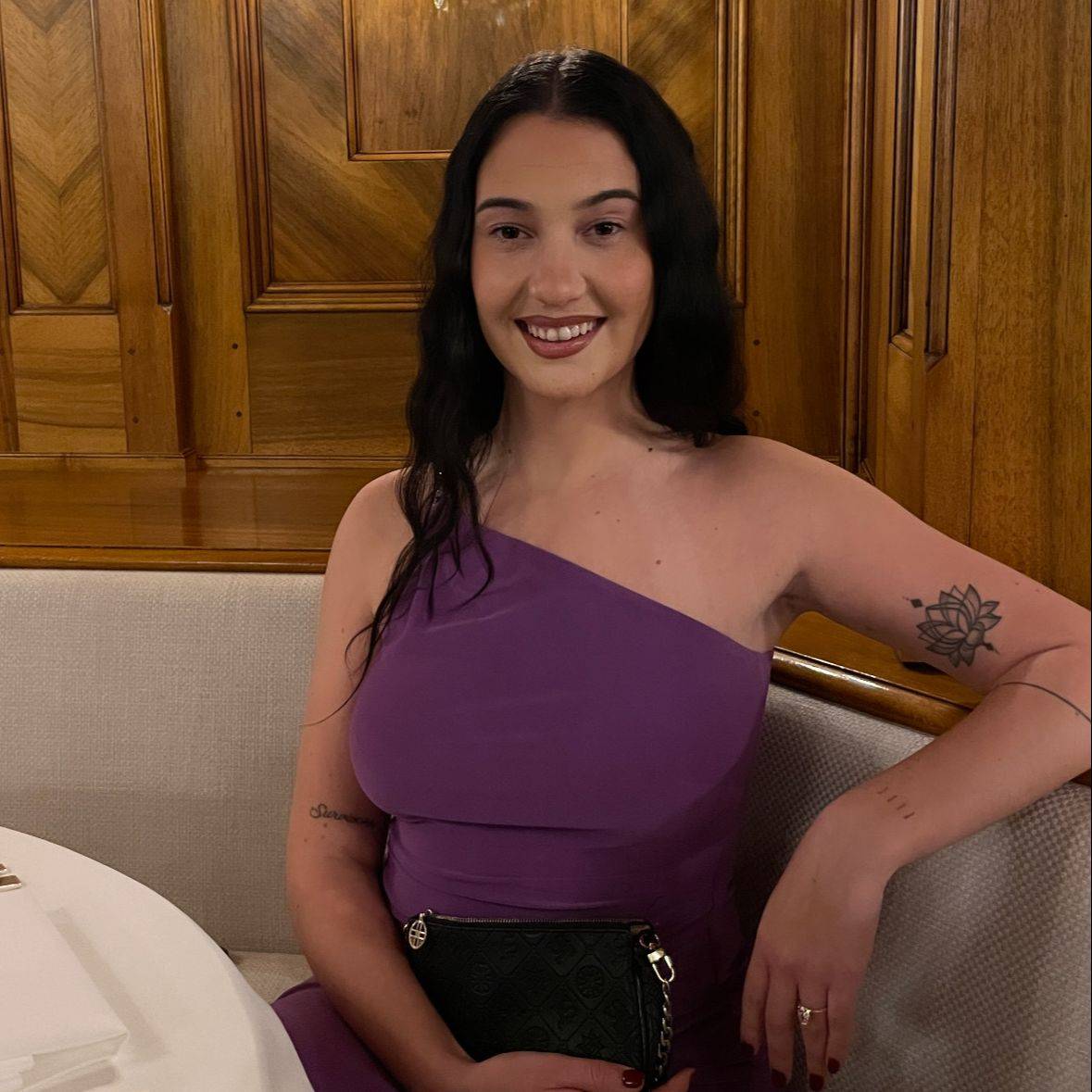 Kyra smiling while seated