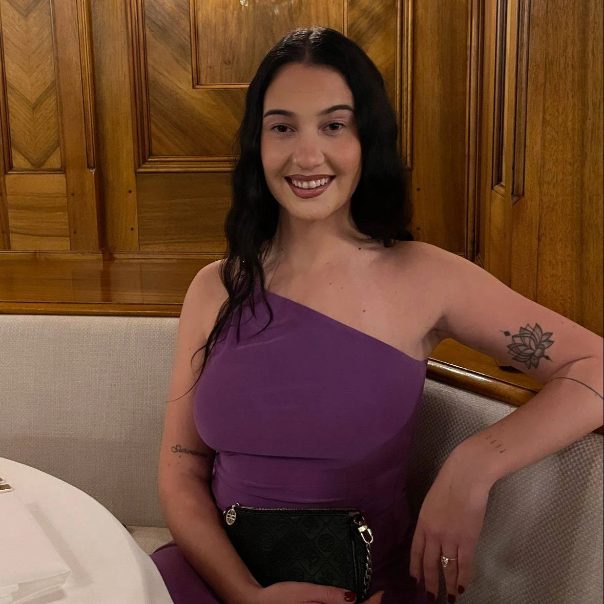 Kyra smiling while seated