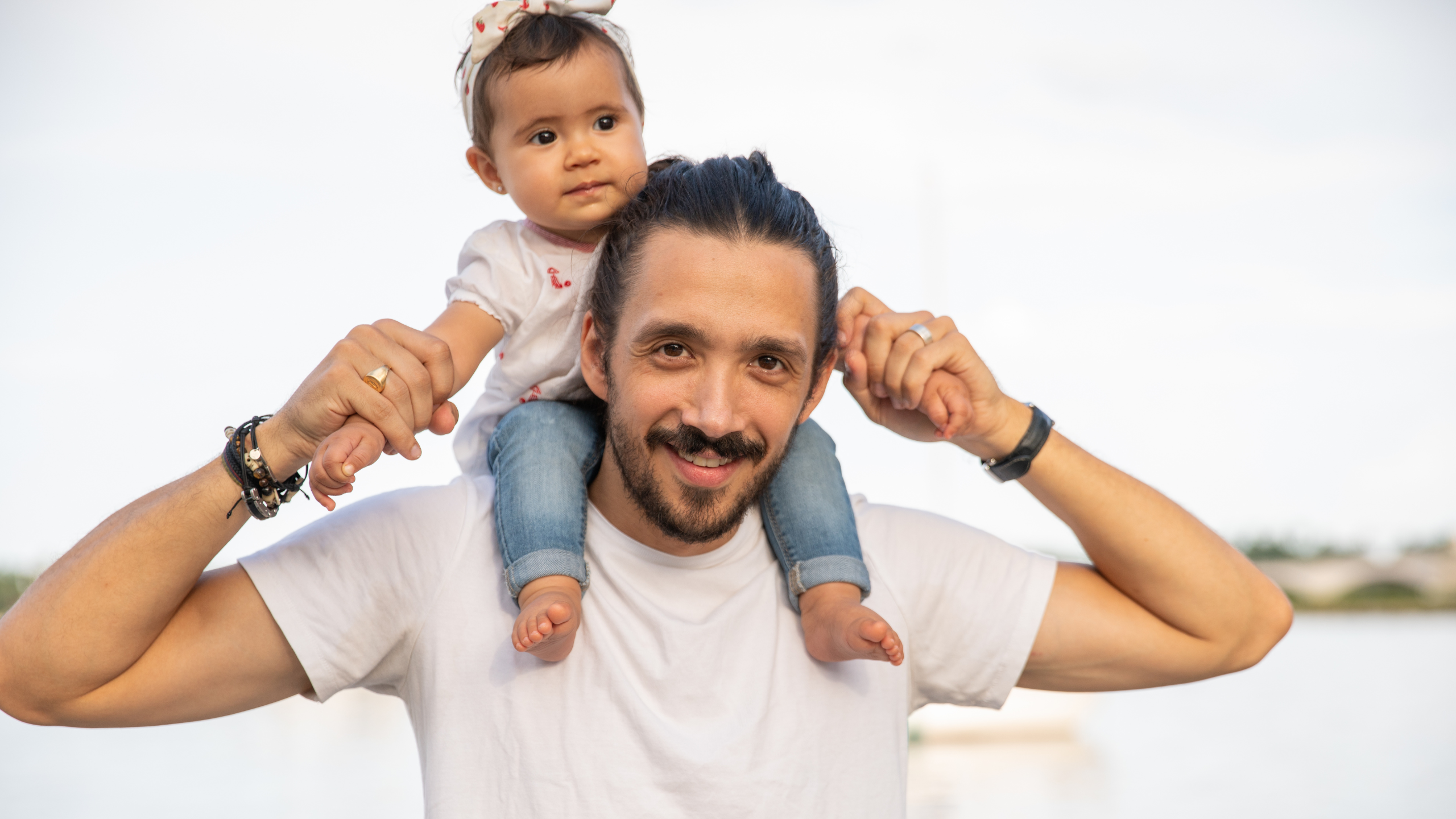 A father with his daughter on his shoulders