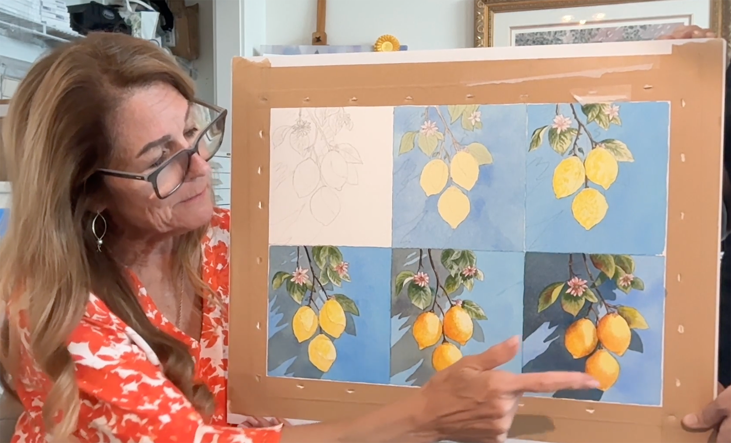 Pomm holding five boards of the same lemon painting, one at each of the five phases