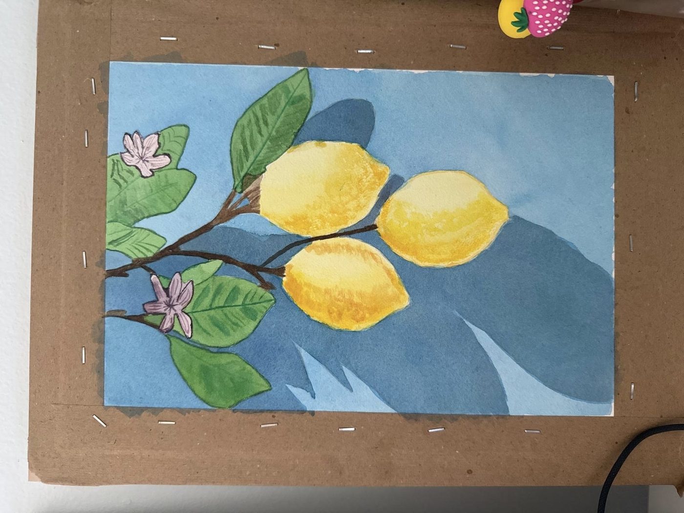 A watercolor of three lemons with deep blue cast shadows