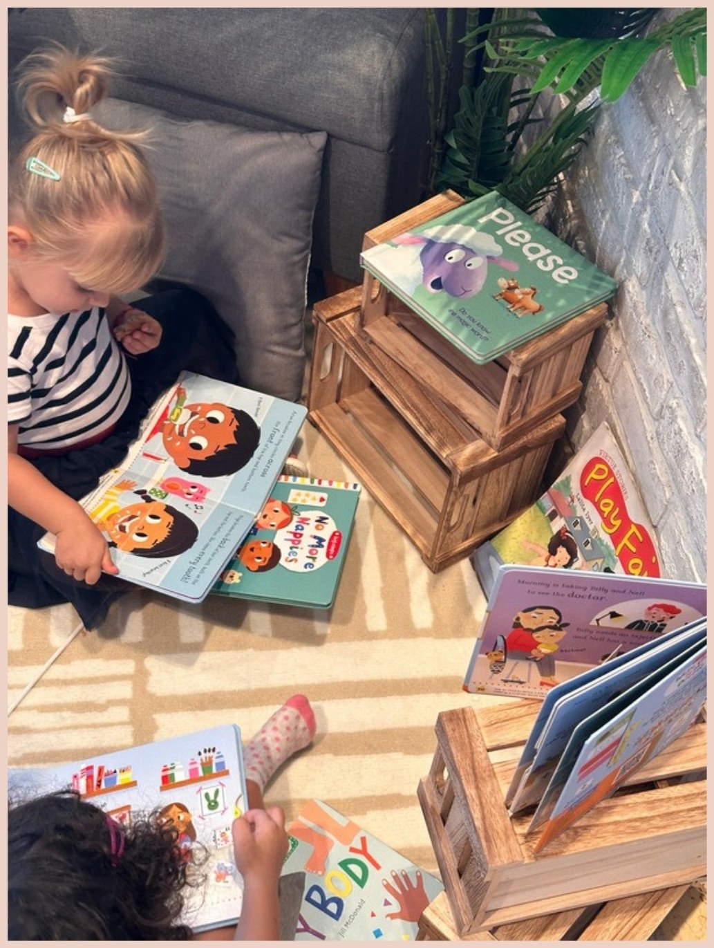 Little ones reading board books together, including No More Nappies, at story time
